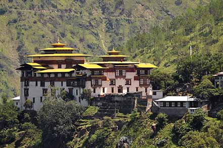 Dzong with yellow rooft and green trees