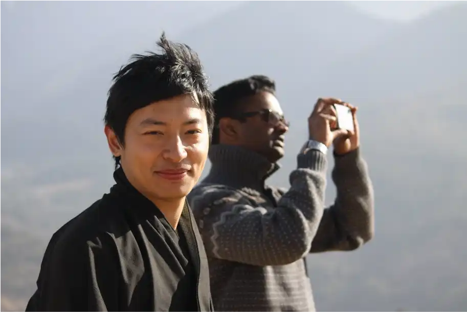 men with fair face and wearing black oufit and one guy behind him