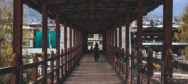Men walking on wood bridge