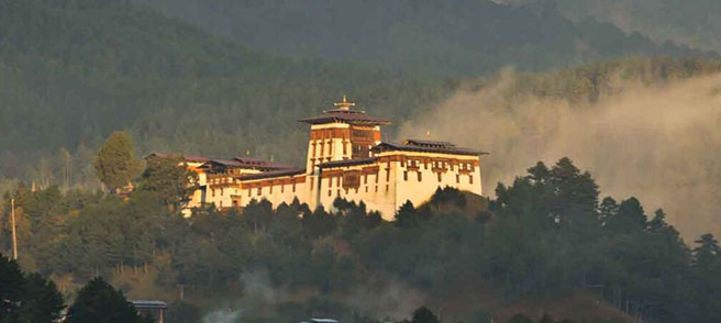 Dzong ontop of hill and mountain behind it
