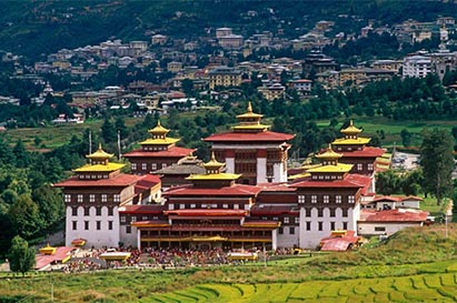 Dzong surrounded by trees and settelments