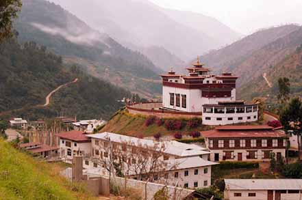 monastery white and mountain behind it