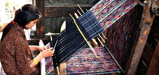 bhutanese women weaving in traditional